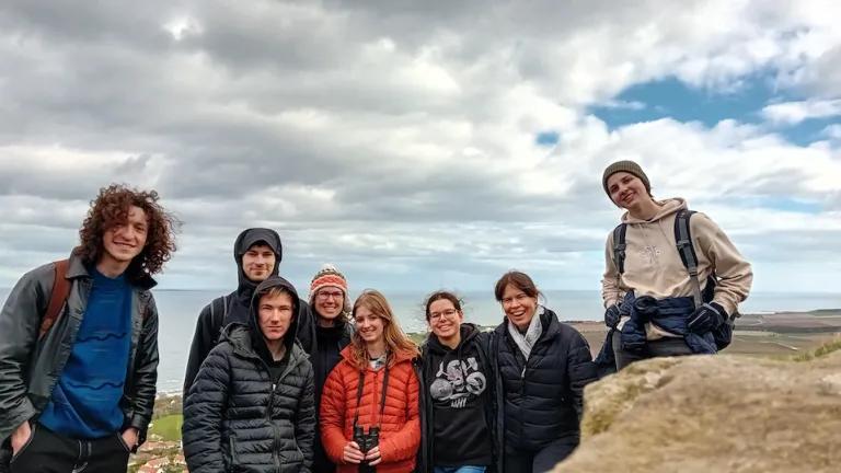 Group photo of 8 lab members on top of North Berwick Law