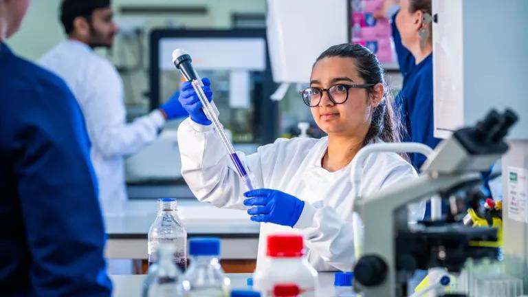 Student pipetting in a lab