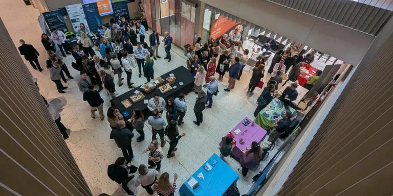 A crowd of people networking at a conference