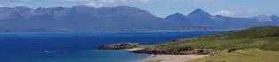 Landscape image of a bay on the Isle of rum, and the view out across the water to other mountainous islands