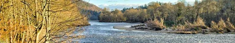 A river flows through a wooded landscape