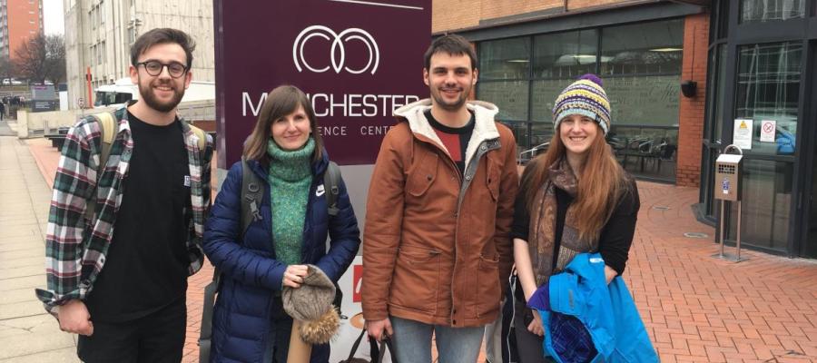 Four members of the lab pose for a photo outside the Dynamic Cell conference