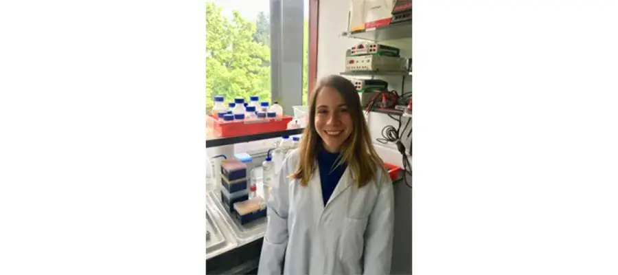 Gediz Kocaoglan standing in the lab and smiling.