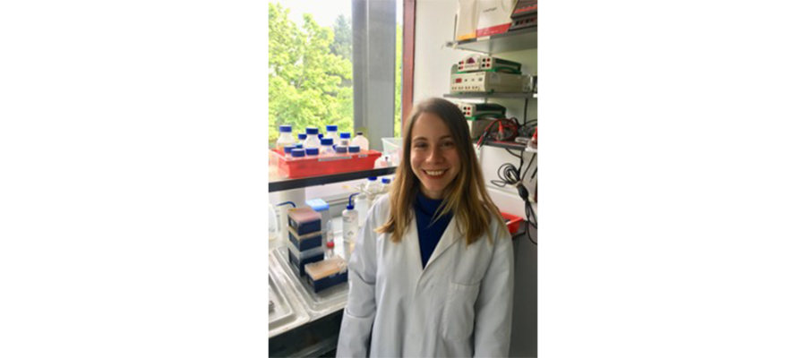 Gediz Kocaoglan standing in the lab and smiling.