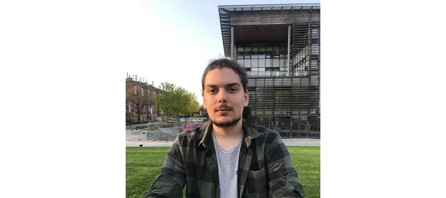Konstantinos Tsaridis sitting on grass.