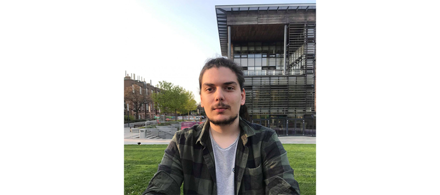 Konstantinos Tsaridis sitting on grass.