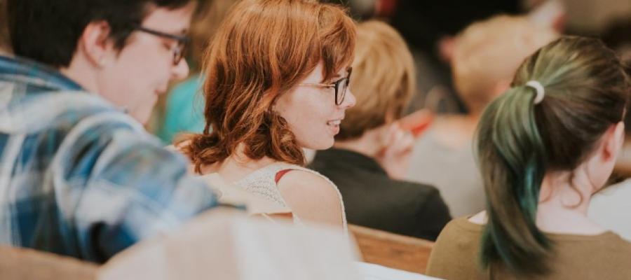 A group of students in a lecture theatre phograped from close by