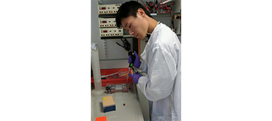 Franklin Lo deep in thought in the lab.