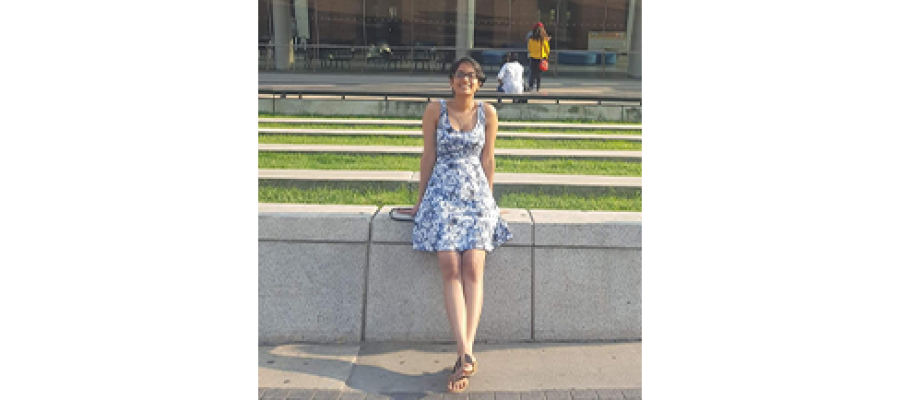 Jovanna Maharaj standing in a dress outside.