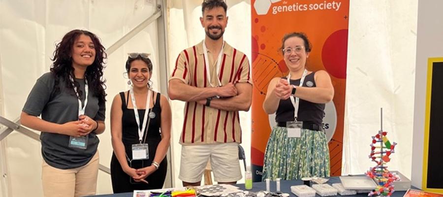 Hardwick lab group members stand behind a stall at a science public engagement event