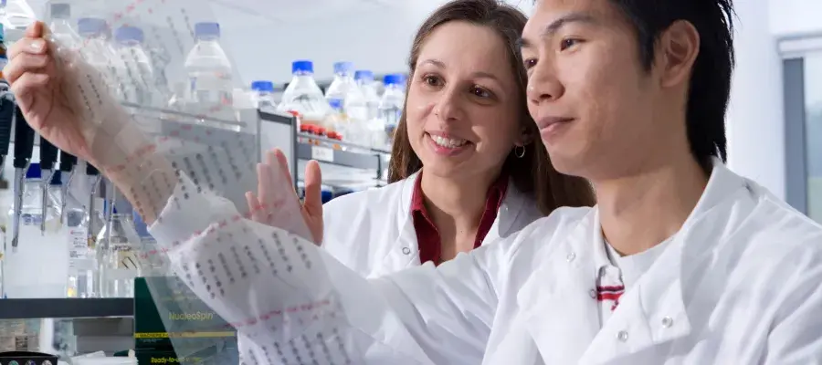 Two students analysing data in a laboratory