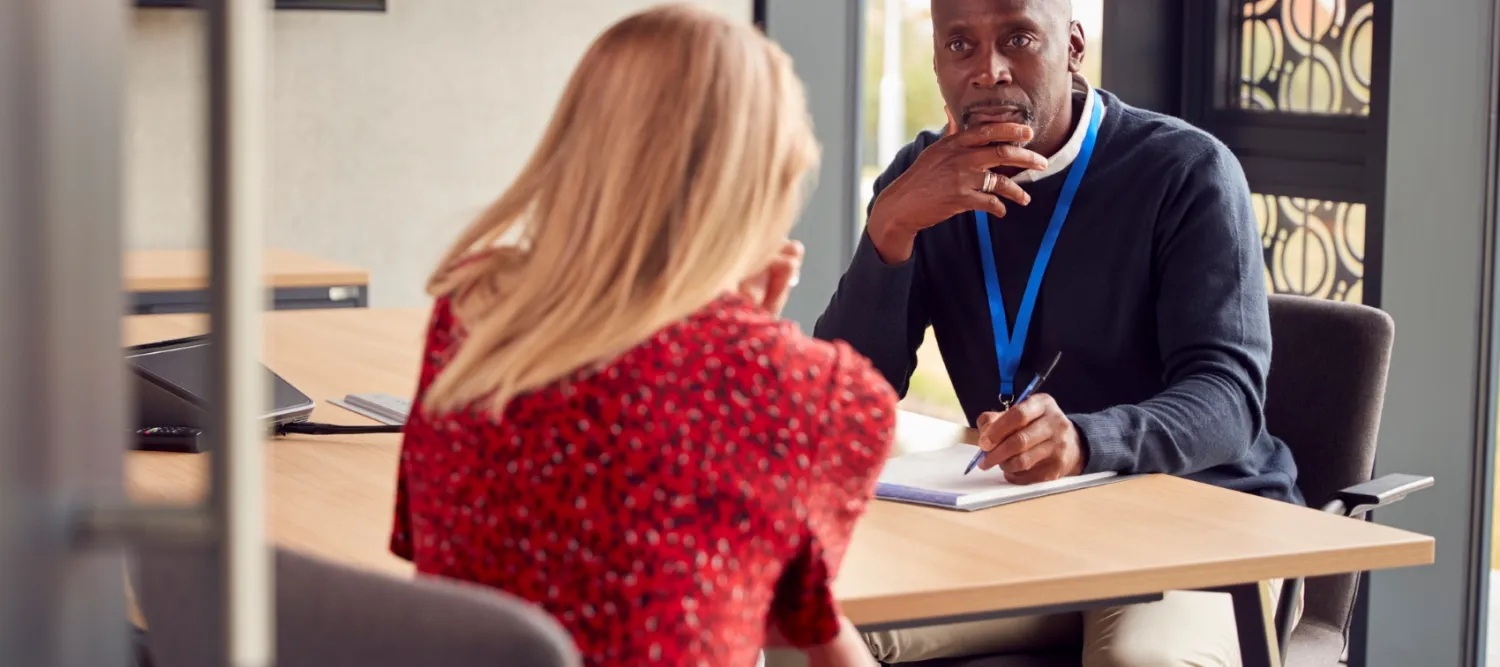 Two staff members discussing ideas in a meeting