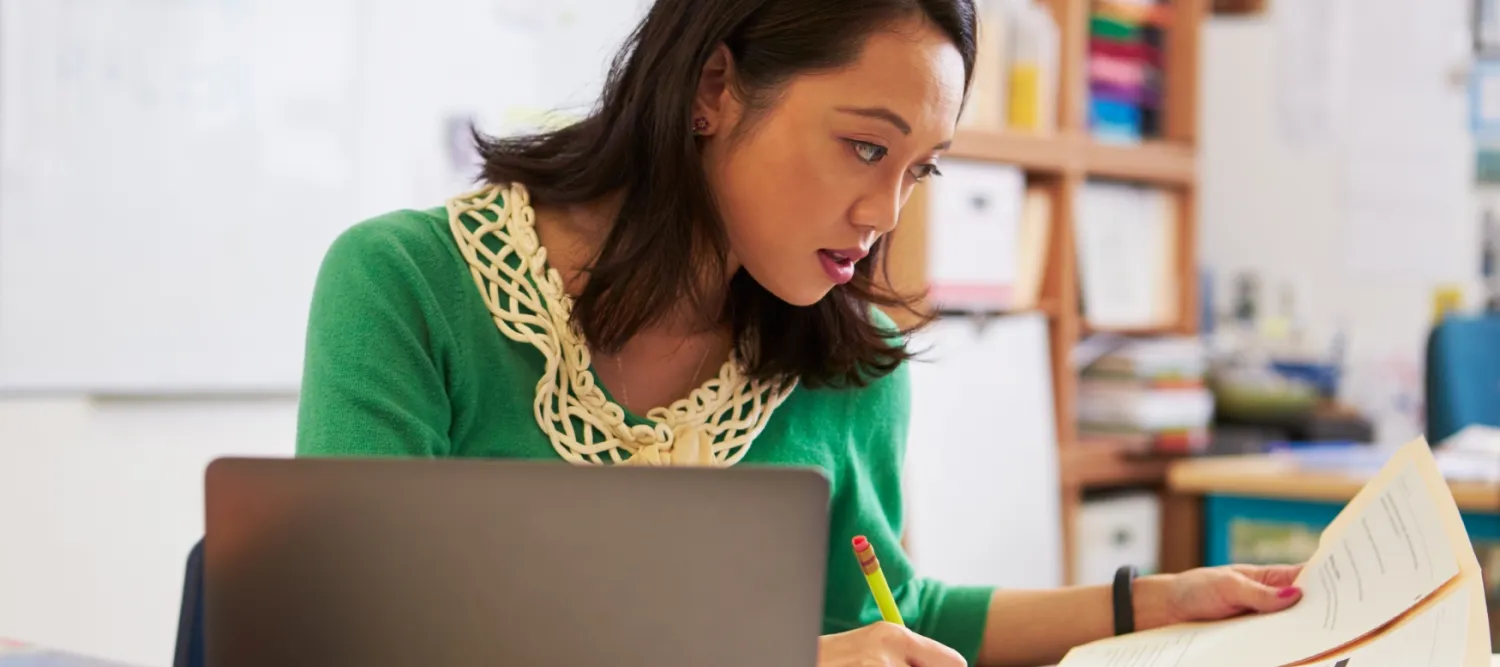Staff member marking an assessment paper