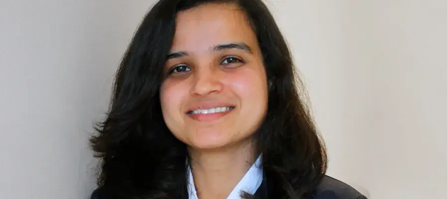 A woman with shoulder length dark hair smiling at the camera