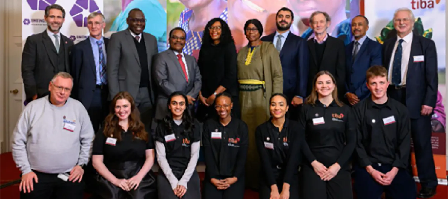 Photo from P.I.G.s annual report 24-25 cover, showing a group of people in two rows, standing at the back, sitting at the front, posing for a photo