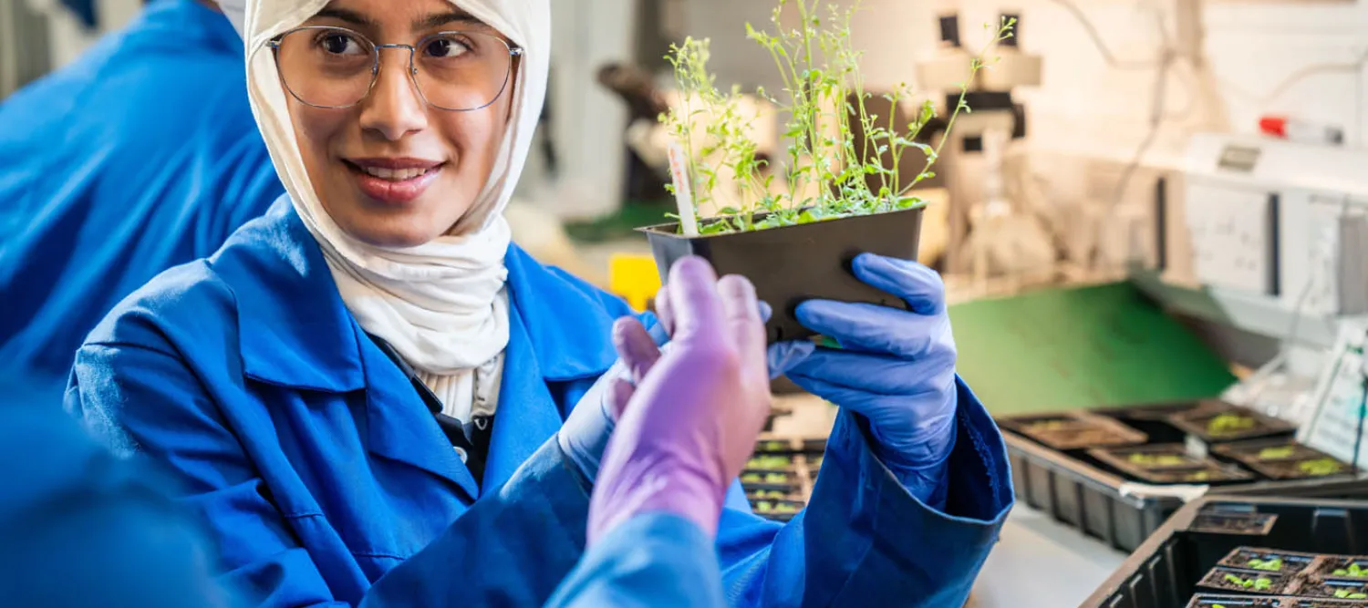 student looking at plant