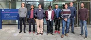 Professor Chris French with his research group standing in front of Roger Land Building