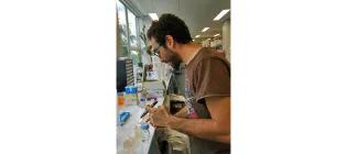 Andreas working with petri dishes in a lab.
