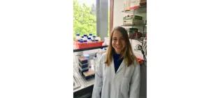 Gediz Kocaoglan standing in the lab and smiling.