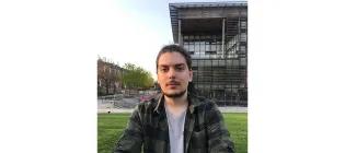 Konstantinos Tsaridis sitting on grass.