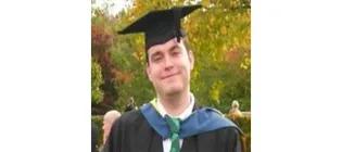 Headshot of Dr. Craig Munns in his graduation cap and gown.