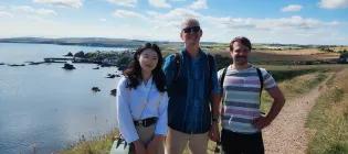 Group photo from 2024 of Justin, Jiayue and Philippe on a walk near Eyemouth.