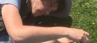 Richard Milne taking a photo of a wild plant
