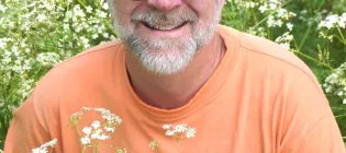Graham Stone in field of flowers