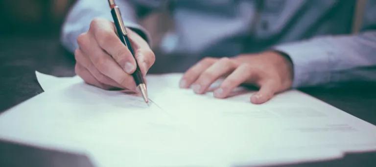 Man writes on paper