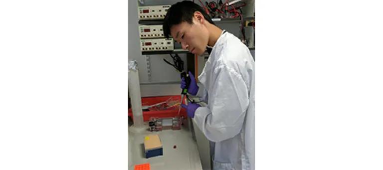 Franklin Lo deep in thought in the lab.
