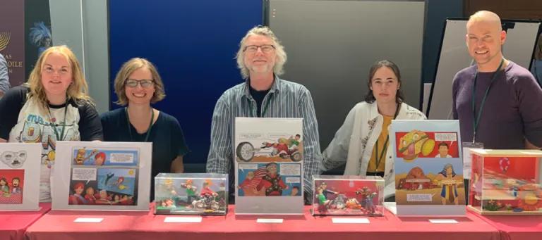Lab group members at a stand during a PE event