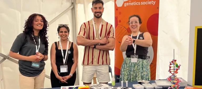 Hardwick lab group members stand behind a stall at a science public engagement event