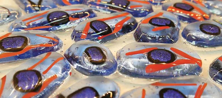 Sculpted glass made to look like cells in blue, purple and orange