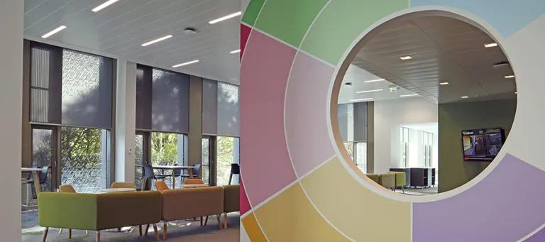 Photo of the entrance to the Nucleus' Careers Service space, witha colourful circle divider and tables and chairs near a window