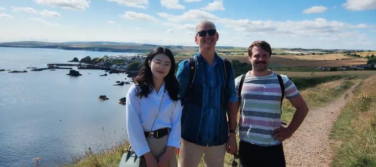 Group photo from 2024 of Justin, Jiayue and Philippe on a walk near Eyemouth.