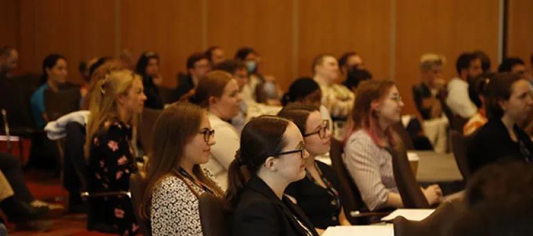 A group of students sit looking towards the front of room for a workshop