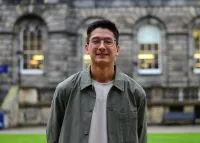 Image of Benedict in front of building