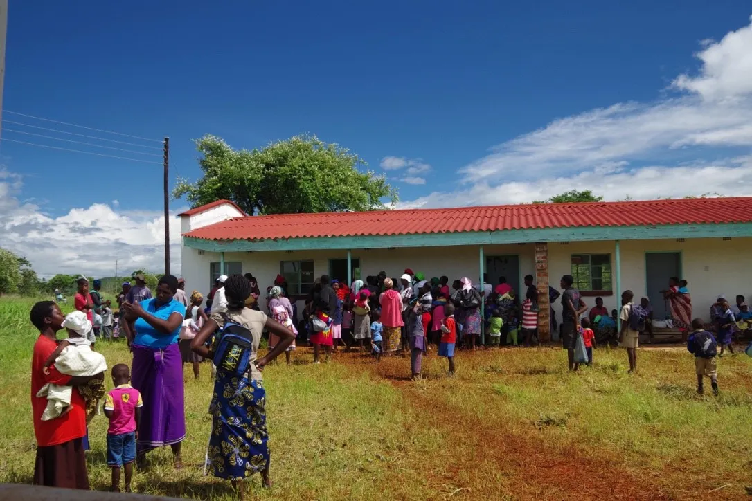 Photo of local villagers outside a building