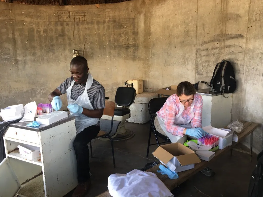 Photo of two healthcare workers hadling samples