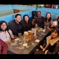 Group members gathered round a table to share a meal