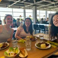 A group of people sitting at a table with food