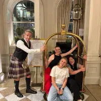 A group of people sitting on a cart