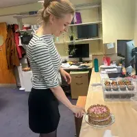 A person cutting a cake