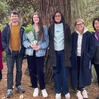 Six people stand infront a large tree at the Royal Botanic Garden Edinburgh