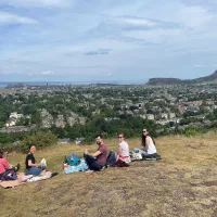 Five people having a picnic on Blackford Hill on a sunny day