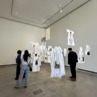 Students looking at exhibition piece