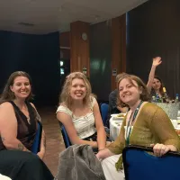 Taylor, Louise and Wulfrun smiling at the conference dinner