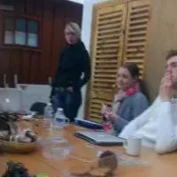 Panorma photo of the lab group sitting around a table indoors