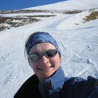 A selfie of Julie Blyth on the slope, in ski suit and sunglasses