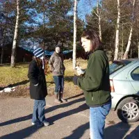 Lab members in the car park, with cars and trees nearby